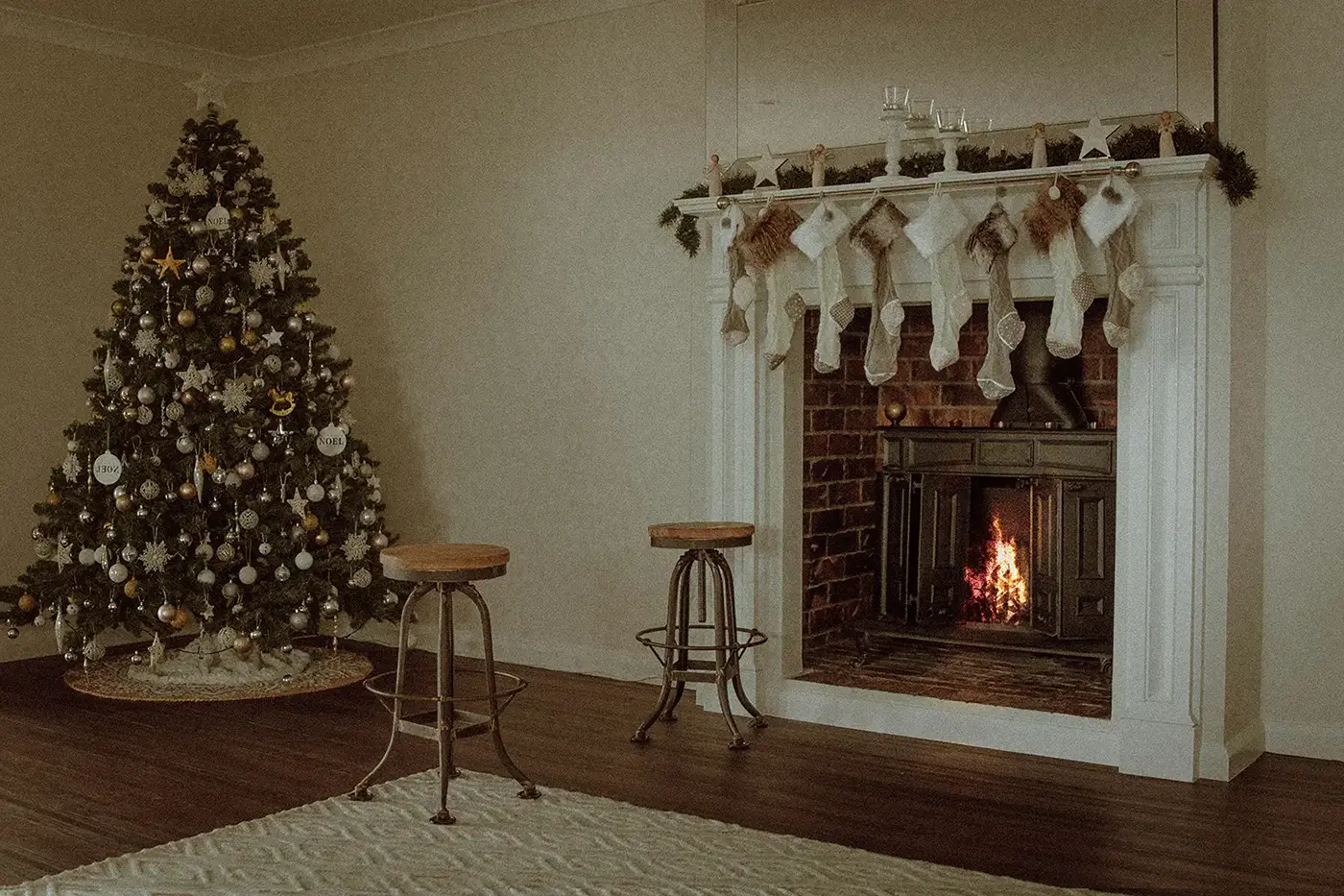 Minimalist interior with knitted socks on the fireplace and a christmas tree